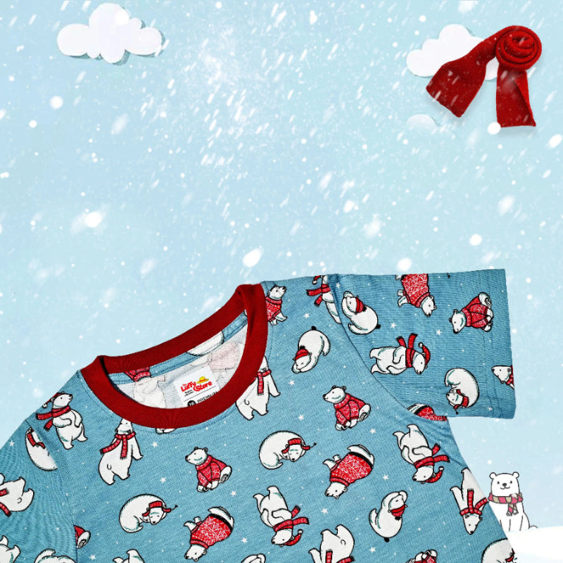 Children's pajama set with polar bear pattern on a blue background with snowflakes and clouds.