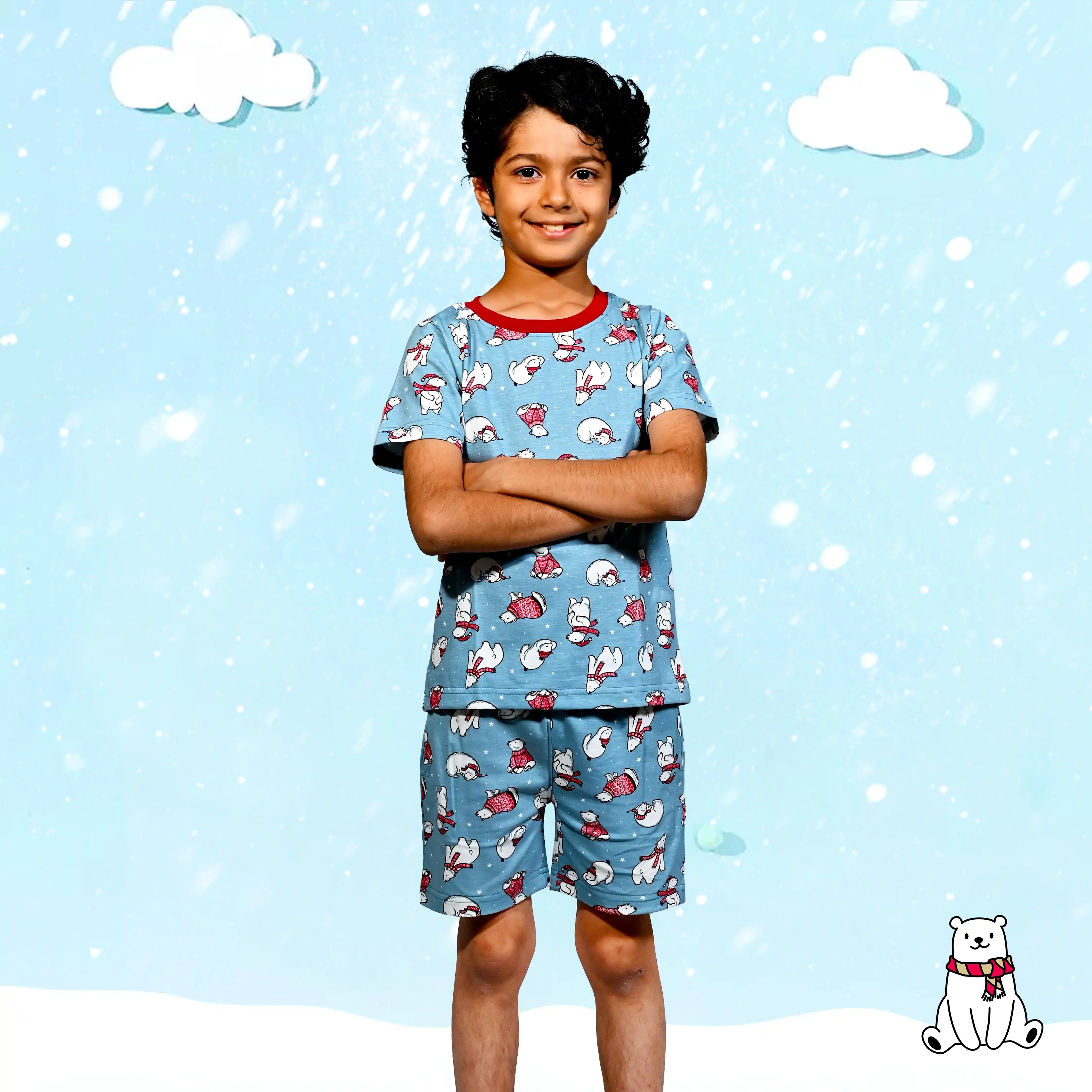 Child wearing a blue pajama set with cartoon characters against a blue sky background