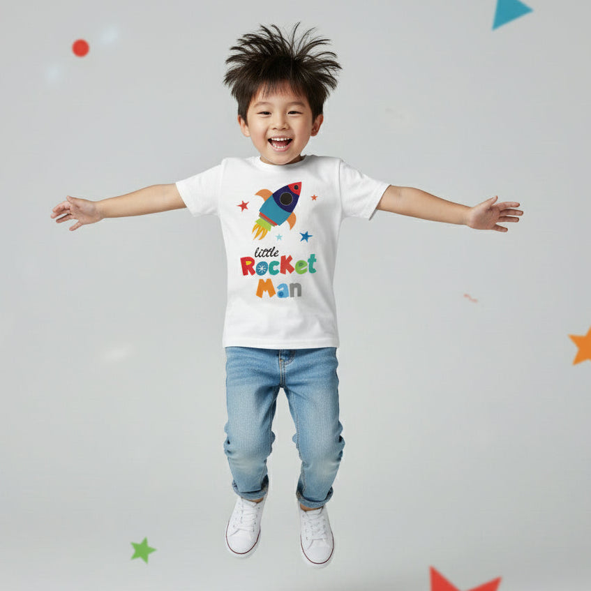 Child wearing a 'Little Rocket Man' t-shirt with colorful graphics on a gray background with stars.