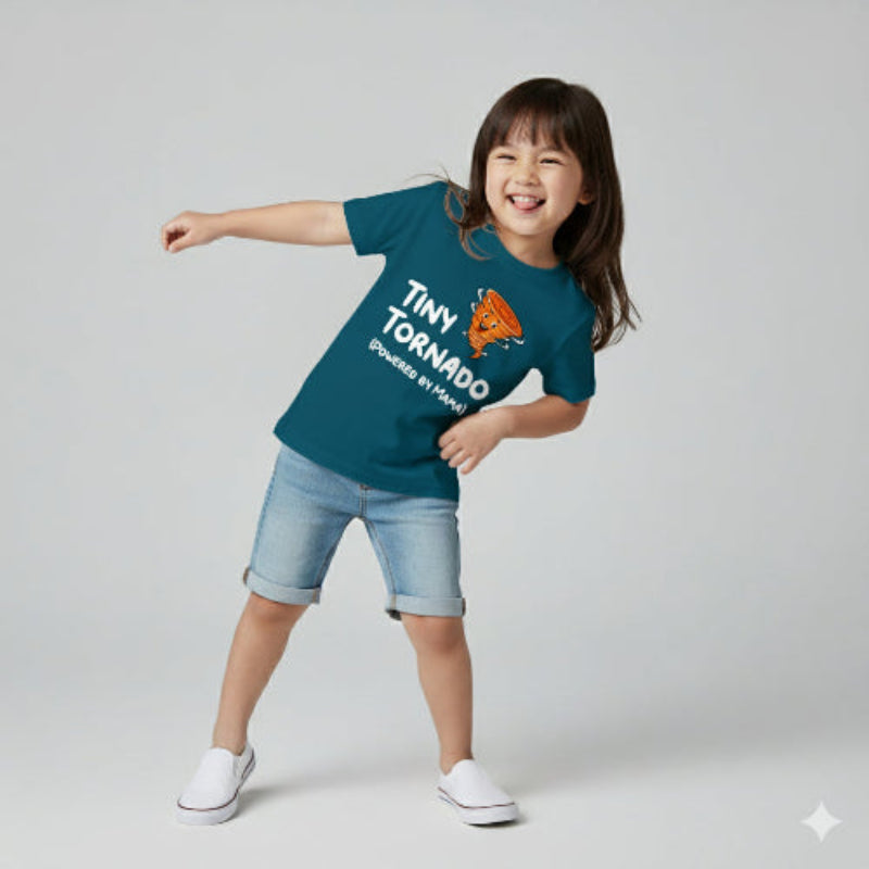 Child wearing a teal t-shirt with 'Tiny Tornado' graphic and text, standing on a light gray background.