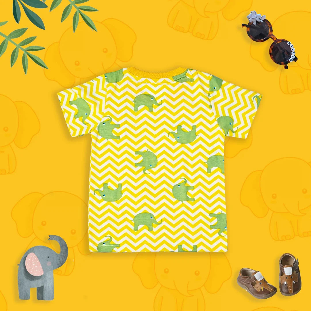 Yellow t-shirt with green elephant pattern on a yellow background with elephant toys.