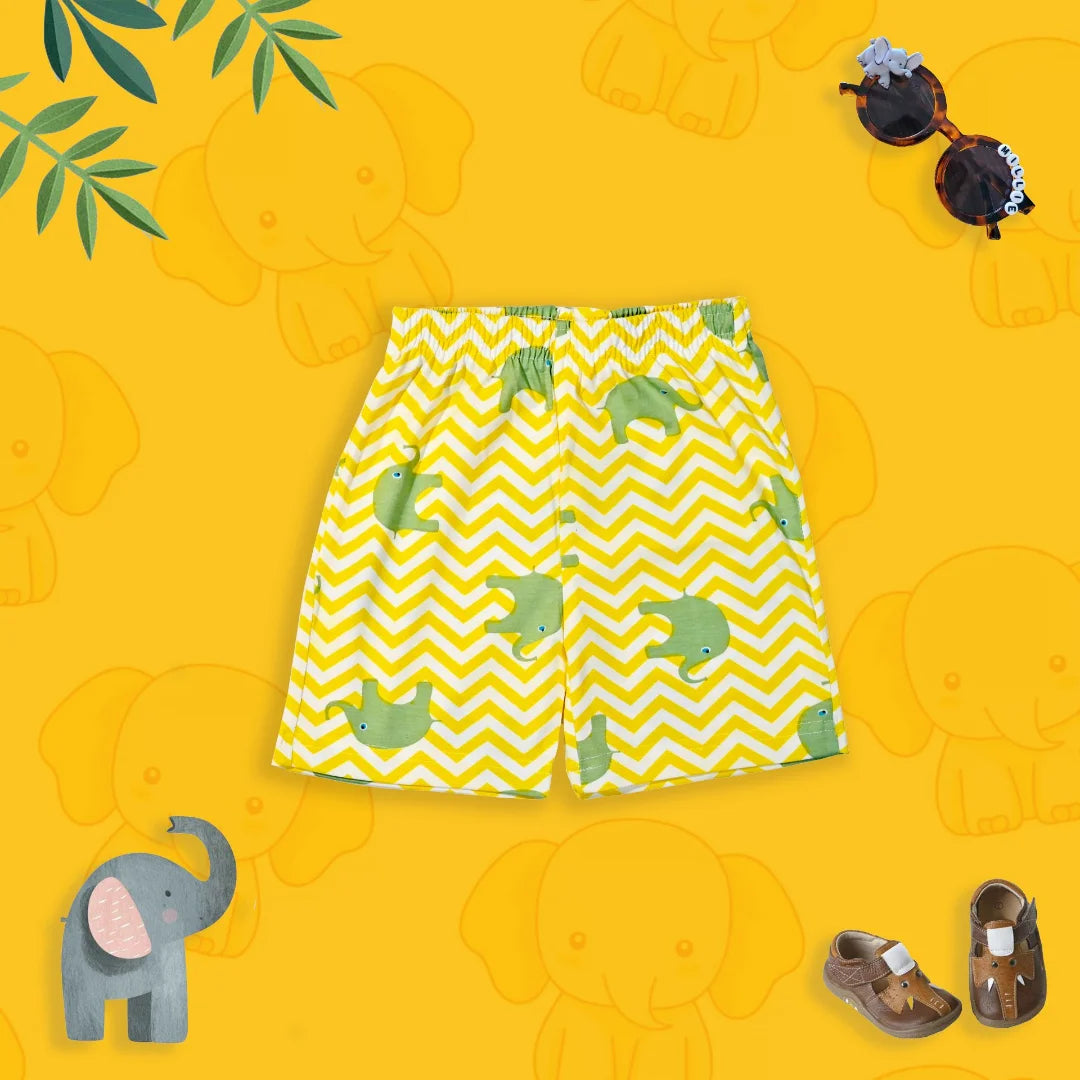 Yellow shorts with green dinosaur pattern on a yellow background with elephant illustrations.