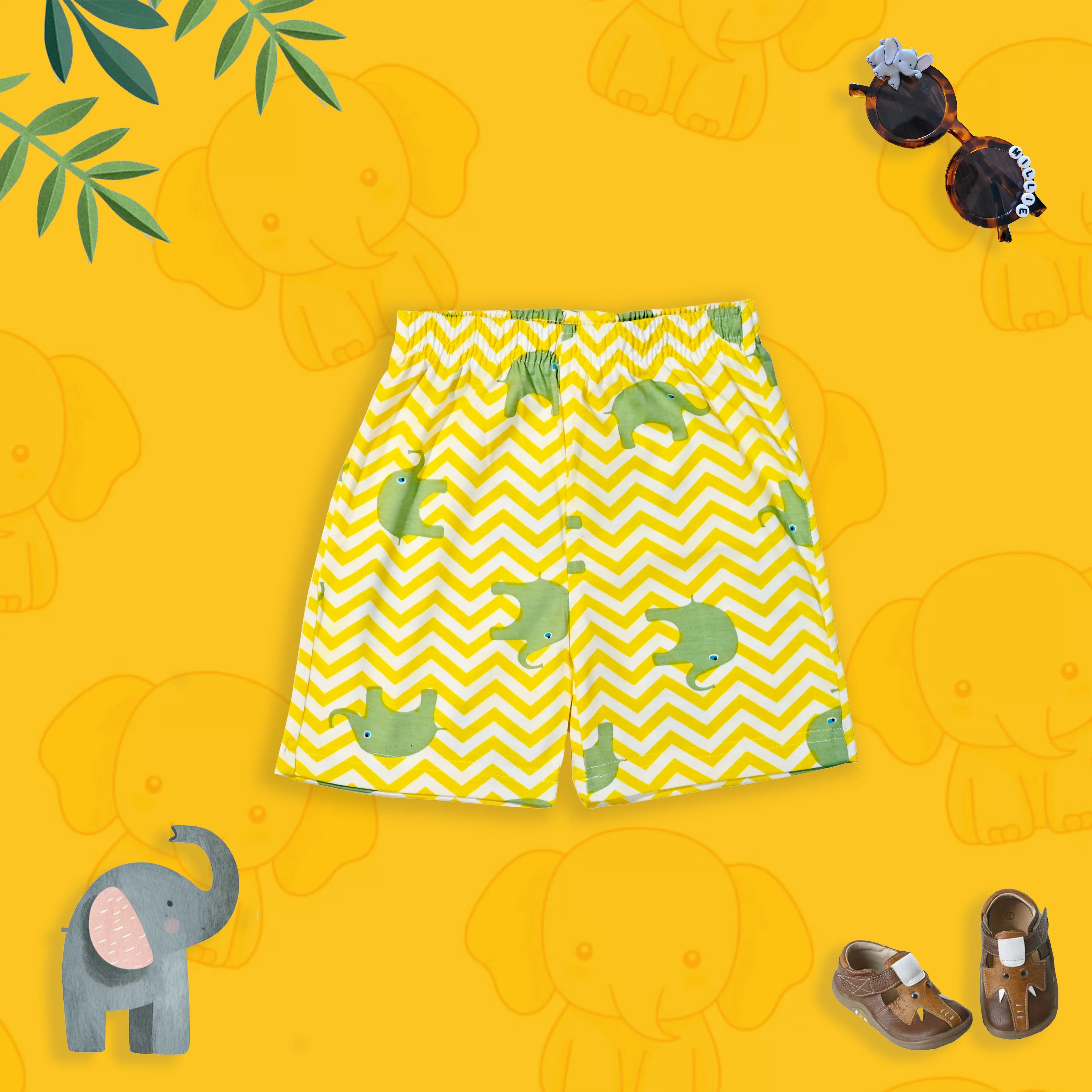 Yellow shorts with green elephant pattern on a yellow background with elephant illustrations