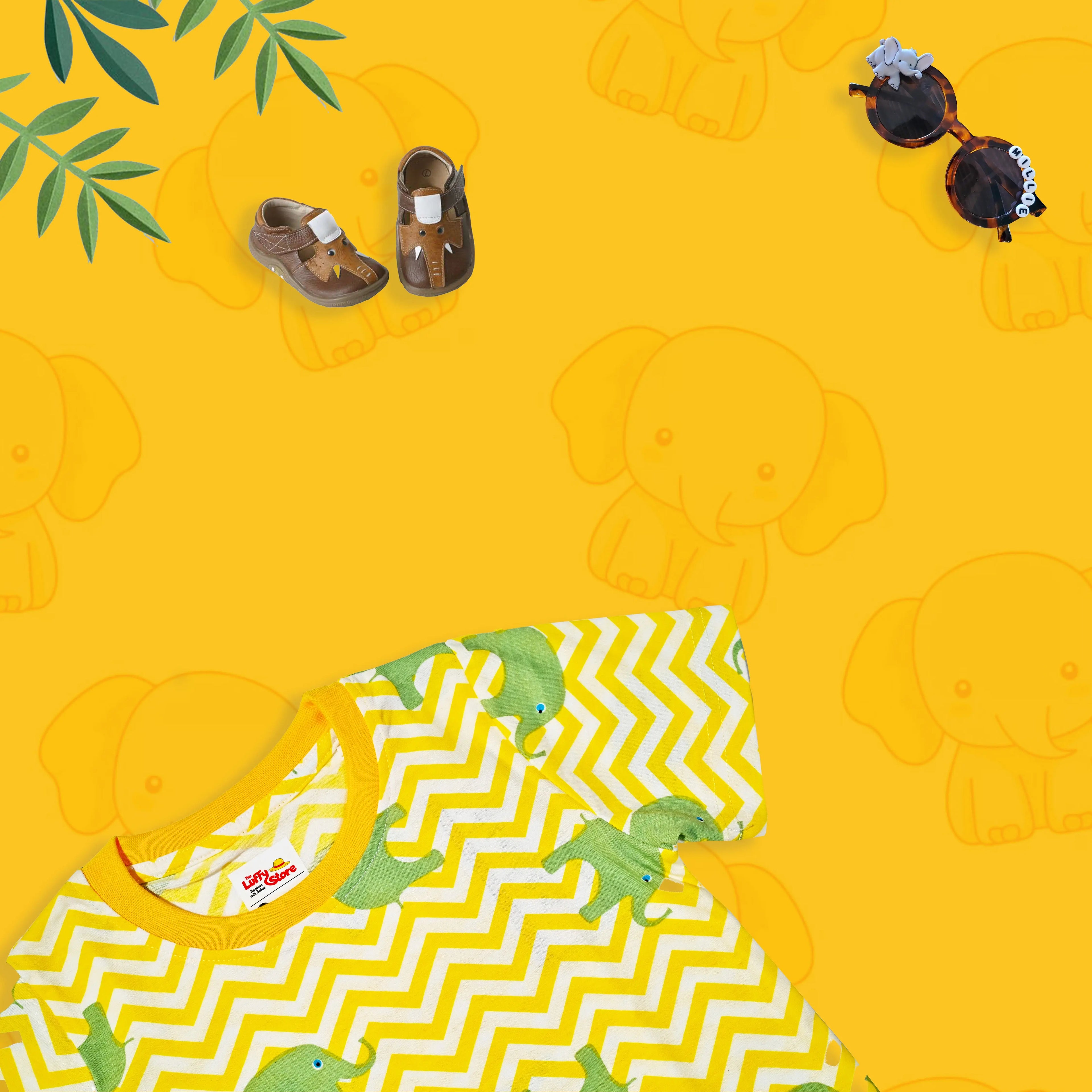 Children's outfit with dinosaur design on a yellow background with elephant patterns